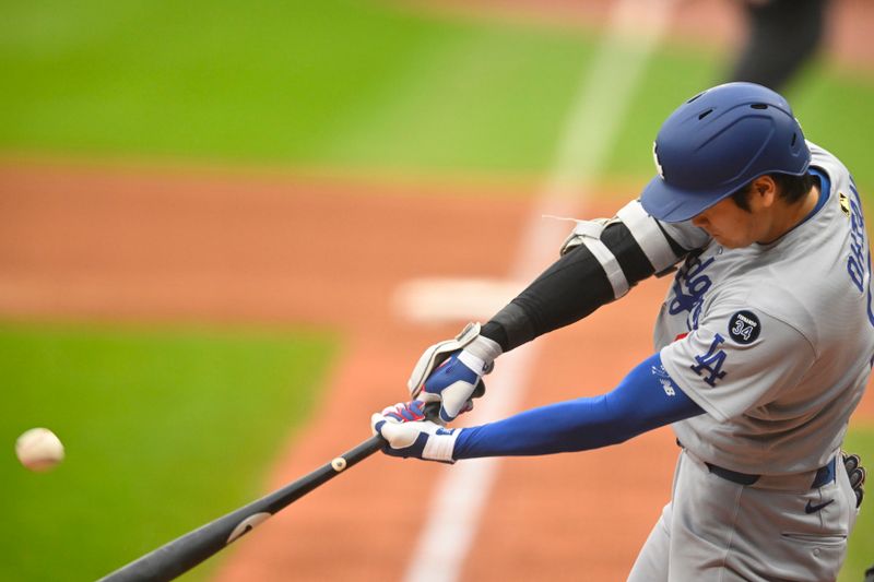 May 27, 2025; Cleveland, Ohio, USA; Los Angeles Dodgers designated hitter Shohei Ohtani (17) hits a two-run home run in the fourth inning against the Cleveland Guardians at Progressive Field. Mandatory Credit: David Richard-Imagn Images