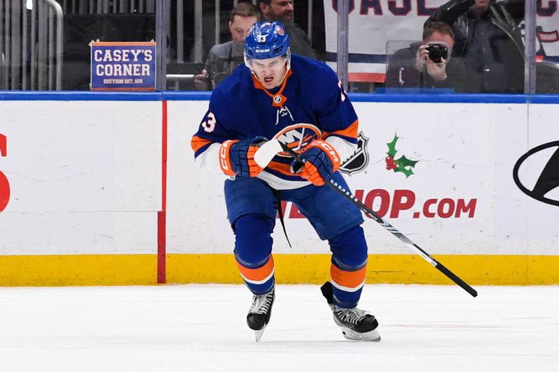 Dec 13, 2023; Elmont, New York, USA; New York Islanders center Mathew Barzal (13) celebrates his goal against the Anaheim Ducks during the third period at UBS Arena. Mandatory Credit: Dennis Schneidler-USA TODAY Sports