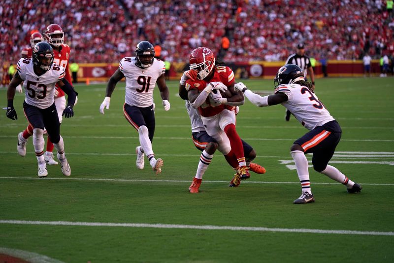 Kansas City Chiefs running back Isiah Pacheco (10) runs with the ball as a host of Chicago Bears defend during the second half of an NFL football game Sunday, Sept. 24, 2023, in Kansas City, Mo. (AP Photo/Charlie Riedel)