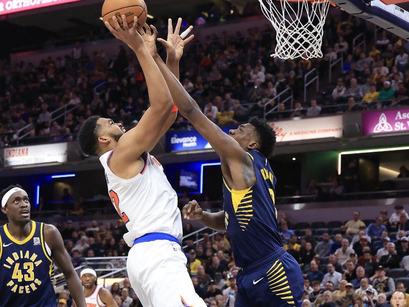 INDIANAPOLIS, INDIANA - FEBRUARY 11: Karl-Anthony Towns #32 of the New York Knicks is fouled by Thomas Bryant #3 of the Indiana Pacers during the first half at Gainbridge Fieldhouse on February 11, 2025 in Indianapolis, Indiana. NOTE TO USER: User expressly acknowledges and agrees that, by downloading and or using this photograph, User is consenting to the terms and conditions of the Getty Images License Agreement. (Photo by Justin Casterline/Getty Images)