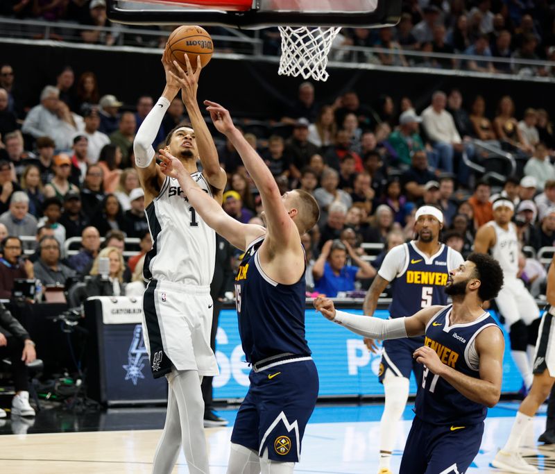 AUSTIN, TX - MARCH 15: Victor Wembanyama #1 of the San Antonio Spurs shoots over Nikola Jokic #15 of the Denver Nuggets in the first half at Moody Center on March 15, 2024 in Austin, Texas. NOTE TO USER: User expressly acknowledges and agrees that, by downloading and or using this photograph, User is consenting to terms and conditions of the Getty Images License Agreement. (Photo by Ronald Cortes/Getty Images)