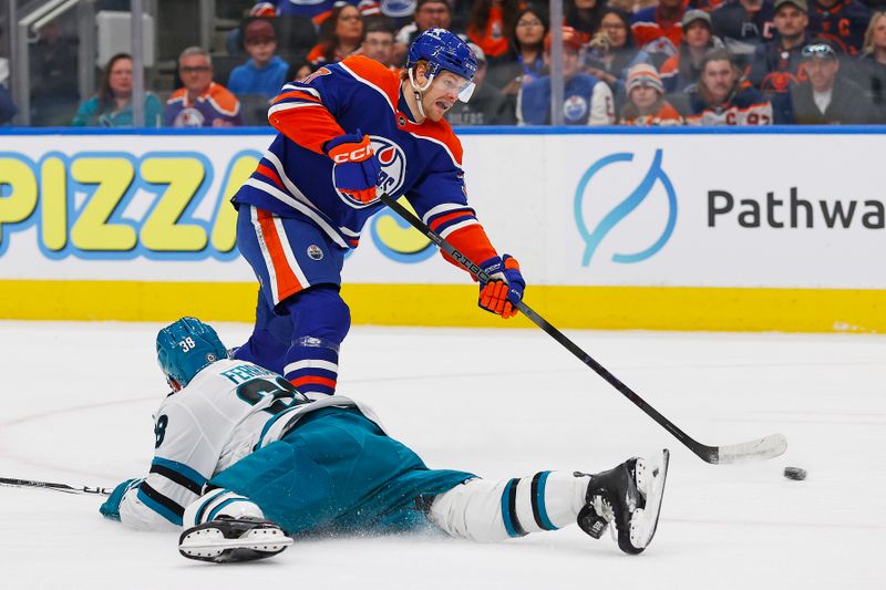 Apr 15, 2024; Edmonton, Alberta, CAN; Edmonton Oilers forward Warren Foegele (37) takes a shot in front of San Jose Sharks defensemen Mario Ferraro (38) during the first period at Rogers Place. Mandatory Credit: Perry Nelson-USA TODAY Sports