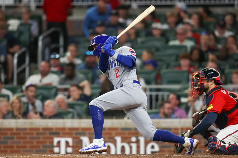 Sep 28, 2023; Atlanta, Georgia, USA; Chicago Cubs second baseman Nico Hoerner (2) hits a single against the Atlanta Braves in the sixth inning at Truist Park. Mandatory Credit: Brett Davis-USA TODAY Sports