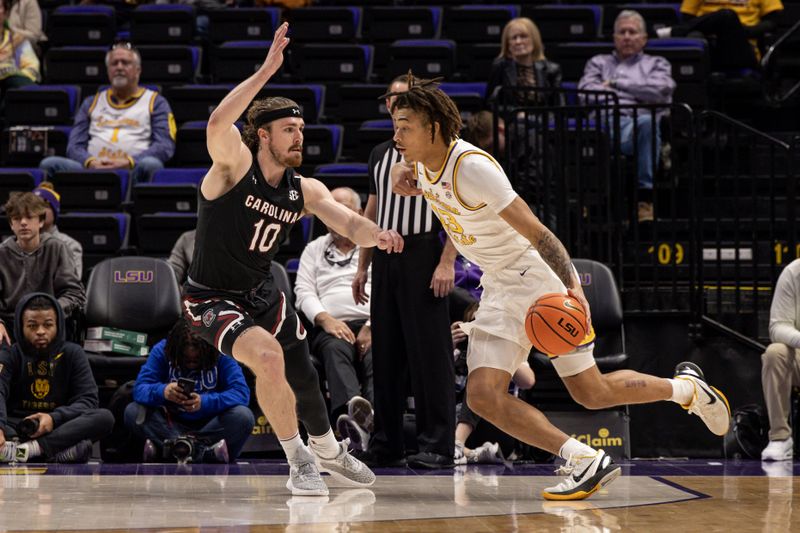 Feb 18, 2023; Baton Rouge, Louisiana, USA; LSU Tigers forward Jalen Reed (13) dribbles against South Carolina Gamecocks forward Hayden Brown (10) during the second half at Pete Maravich Assembly Center. Mandatory Credit: Stephen Lew-USA TODAY Sports