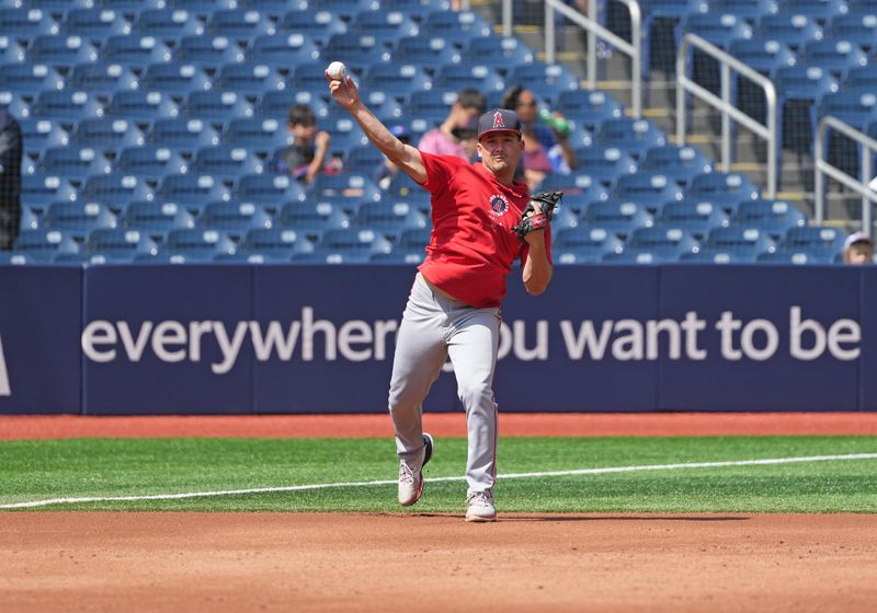 Aug 25, 2024; Toronto, Ontario, CAN; Los Angeles Angels catcher Matt Thaiss (21) throws a ball to fist base during batting practice before a game against theToronto Blue Jays at Rogers Centre. Mandatory Credit: Nick Turchiaro-USA TODAY Sports