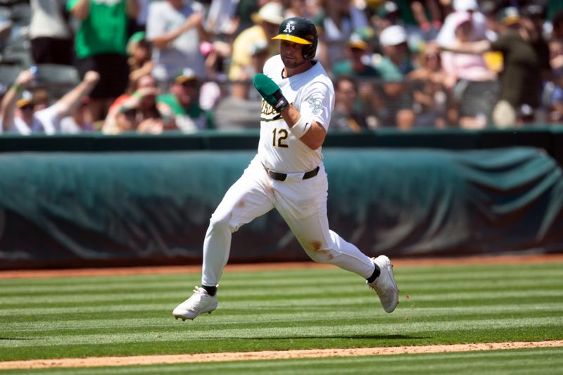 Jul 20, 2024; Oakland, California, USA; Oakland Athletics shortstop Max Schuemann (12) rounds third and heads home on a three-RBI double by Lawrence Butler against the Los Angeles Angels during the fourth inning at Oakland-Alameda County Coliseum. Mandatory Credit: D. Ross Cameron-USA TODAY Sports