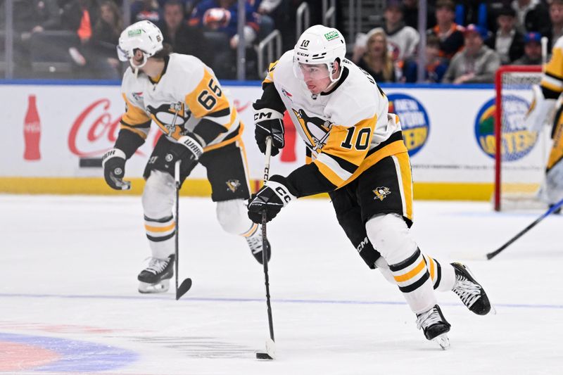 Apr 17, 2024; Elmont, New York, USA;  Pittsburgh Penguins left wing Drew O'Connor (10) skates across center ice against the New York Islanders during the third period at UBS Arena. Mandatory Credit: Dennis Schneidler-USA TODAY Sports