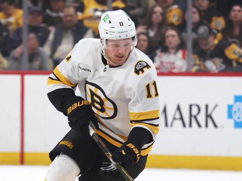 Mar 8, 2026; Pittsburgh, Pennsylvania, USA;  Boston Bruins center Casey Mittelstadt (11) skates with the puck against the Pittsburgh Penguins during the second period at PPG Paints Arena. Mandatory Credit: Charles LeClaire-Imagn Images