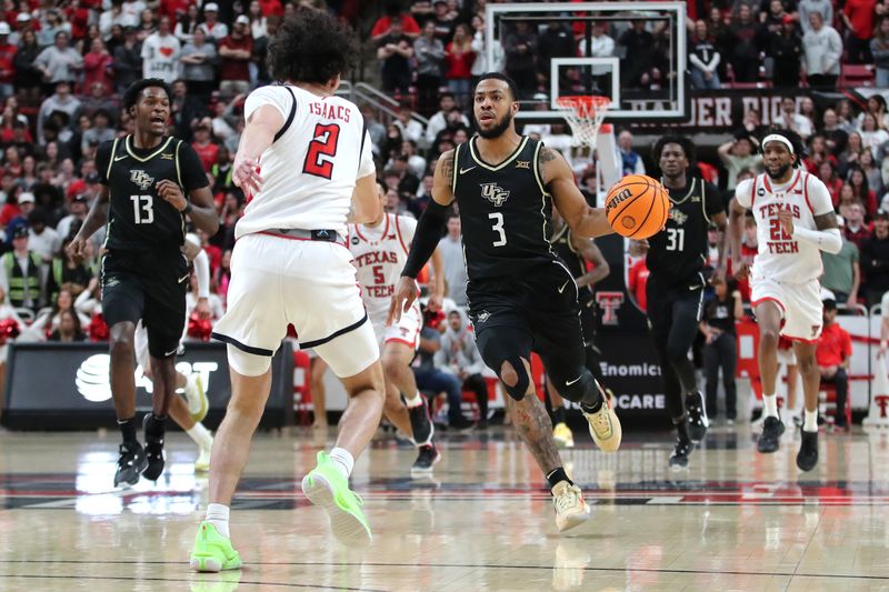 Feb 10, 2024; Lubbock, Texas, USA;  Central Florida Knights guard Darius Johnson (3) brings the ball up court against Texas Tech Red Raiders guard Pop Isaacs (2) in the first half United Supermarkets Arena. Mandatory Credit: Michael C. Johnson-USA TODAY Sports