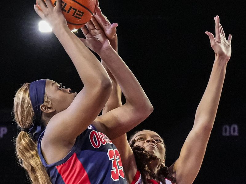 Jan 21, 2024; Athens, Georgia, USA; Ole Miss Rebels forward Kharyssa Richardson (33) shoots over Georgia Bulldogs forward Destiny Thomas (33) during the second half at Stegeman Coliseum. Mandatory Credit: Dale Zanine-USA TODAY Sports