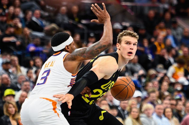 SALT LAKE CITY, UTAH - NOVEMBER 12: Lauri Markkanen #23 of the Utah Jazz drives into Bradley Beal #3 of the Phoenix Suns during the first half of an Emirates NBA Cup game at Delta Center on November 12, 2024 in Salt Lake City, Utah. NOTE TO USER: User expressly acknowledges and agrees that, by downloading and or using this photograph, User is consenting to the terms and conditions of the Getty Images License Agreement. (Photo by Alex Goodlett/Getty Images)