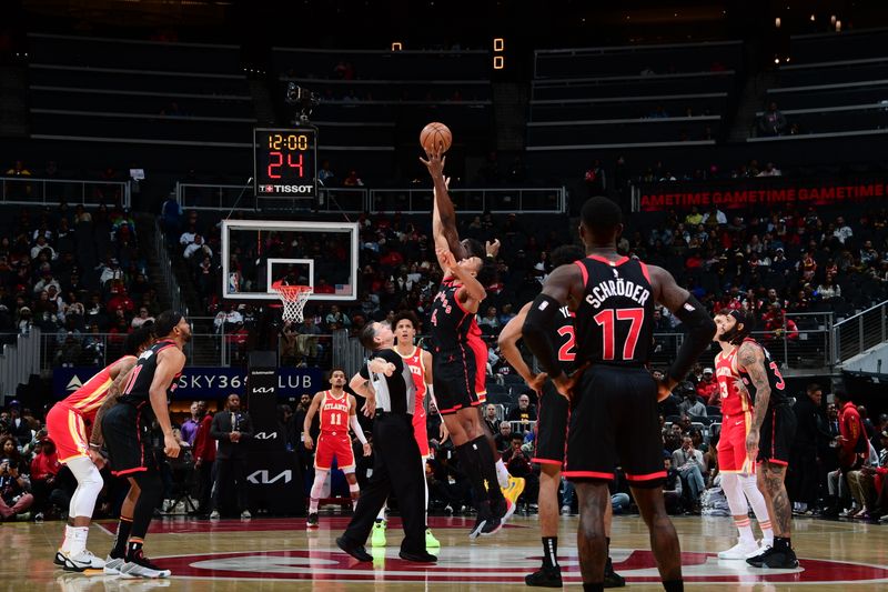 ATLANTA, GA - JANUARY 28: Scottie Barnes #4 of the Toronto Raptors and Clint Capela #15 of the Atlanta Hawks go up for the opening tip off on January 28, 2024 at State Farm Arena in Atlanta, Georgia.  NOTE TO USER: User expressly acknowledges and agrees that, by downloading and/or using this Photograph, user is consenting to the terms and conditions of the Getty Images License Agreement. Mandatory Copyright Notice: Copyright 2024 NBAE (Photo by Scott Cunningham/NBAE via Getty Images)