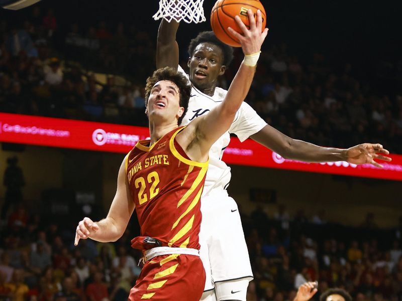 Feb 11, 2025; Orlando, Florida, USA;  Iowa State Cyclones center Milan Momcilovic (22) takes a shot while Central Florida Knights center Moustapha Thiam (52) defends at Addition Financial Arena. Mandatory Credit: Russell Lansford-Imagn Images