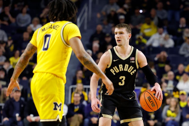 Feb 25, 2024; Ann Arbor, Michigan, USA;  Purdue Boilermakers guard Braden Smith (3) dribbles against Michigan Wolverines guard Dug McDaniel (0) in the second half at Crisler Center. Mandatory Credit: Rick Osentoski-USA TODAY Sports