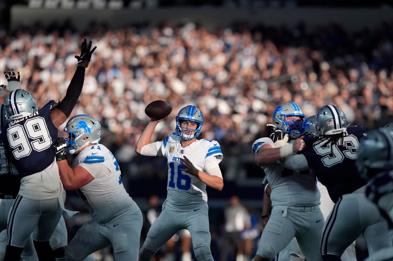 Detroit Lions quarterback Jared Goff drops back to pass under pressure from Dallas Cowboys defensive end Chauncey Golston (99) in the second half of an NFL football game in Arlington, Texas, Sunday, Oct. 13, 2024. (AP Photo/LM Otero)