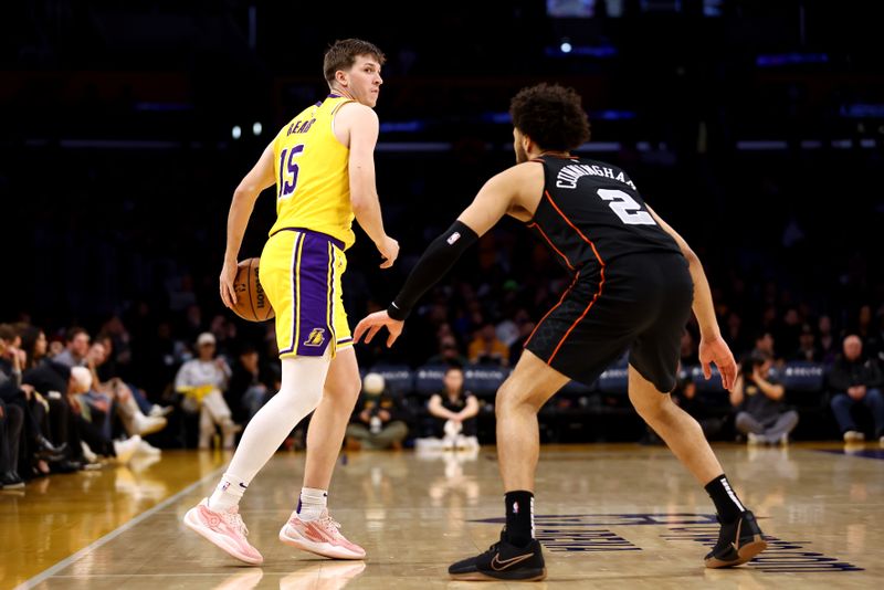 LOS ANGELES, CALIFORNIA - FEBRUARY 13: Austin Reaves #15 of the Los Angeles Lakers dribbles the ball against Cade Cunningham #2 of the Detroit Pistons during the first quarter at Crypto.com Arena on February 13, 2024 in Los Angeles, California. NOTE TO USER: User expressly acknowledges and agrees that, by downloading and or using this photograph, user is consenting to the terms and conditions of the Getty Images License Agreement.  (Photo by Katelyn Mulcahy/Getty Images)