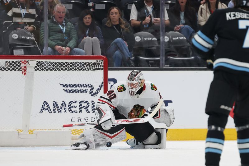 Feb 25, 2025; Salt Lake City, Utah, USA; Chicago Blackhawks goaltender Arvid Soderblom (40) deflects a shot by the Utah Hockey Club during the second period at Delta Center. Mandatory Credit: Rob Gray-Imagn Images