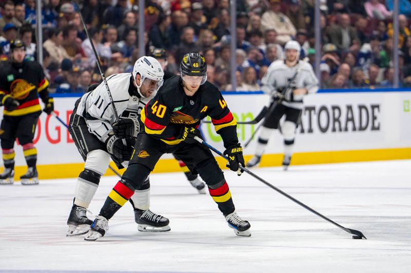 Mar 25, 2024; Vancouver, British Columbia, CAN; Los Angeles Kings forward Anze Kopitar (11) checks Vancouver Canucks forward Elias Pettersson (40) in the second period  at Rogers Arena. Mandatory Credit: Bob Frid-USA TODAY Sports