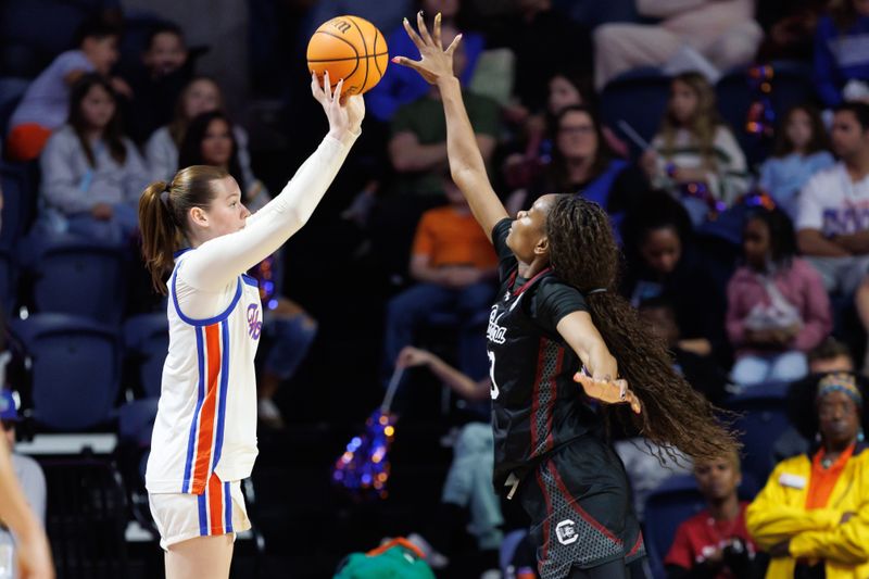 Jan 4, 2026; Gainesville, Florida, USA; Florida Gators forward Caterina Piatti (14) shoots the ball over South Carolina Gamecocks forward Maryam Dauda (30) during the first half at Exactech Arena at the Stephen C. O'Connell Center. Mandatory Credit: Matt Pendleton-Imagn Images