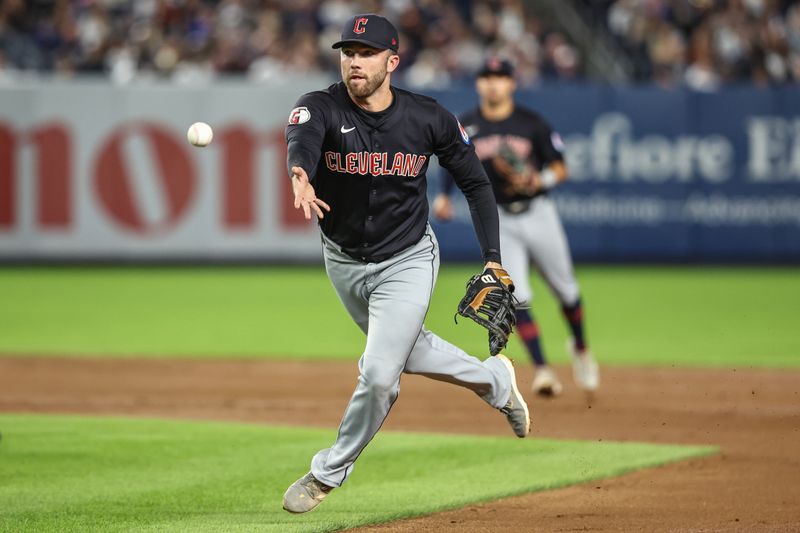 Aug 21, 2024; Bronx, New York, USA;  Cleveland Guardians first baseman David Fry (6) flips the ball to first base in the fourth inning against the New York Yankees at Yankee Stadium. Mandatory Credit: Wendell Cruz-USA TODAY Sports