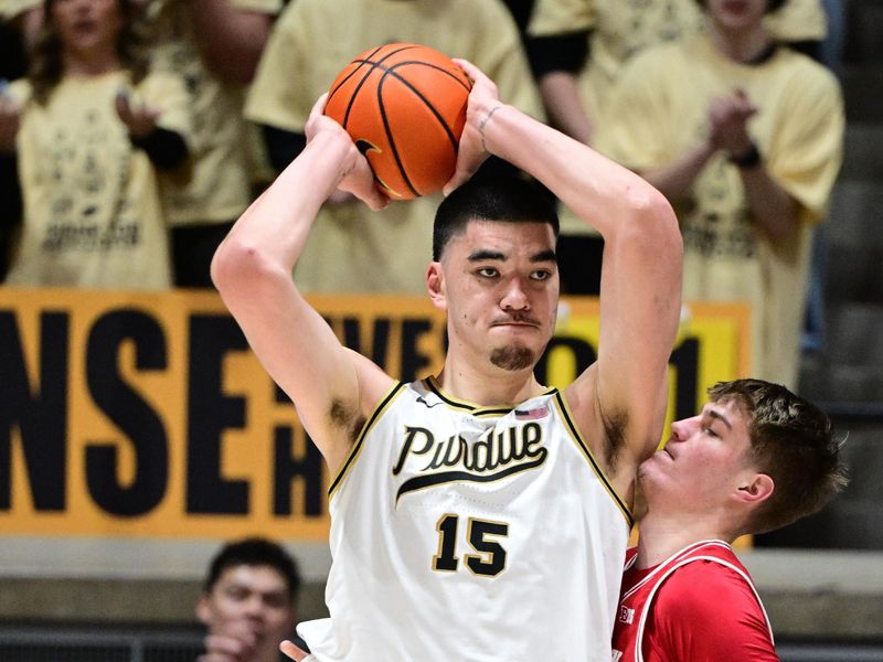 Mar 10, 2024; West Lafayette, Indiana, USA; Purdue Boilermakers center Zach Edey (15) looks to get the ball away from Wisconsin Badgers forward Nolan Winter (31) during the first half at Mackey Arena. Mandatory Credit: Marc Lebryk-USA TODAY Sports