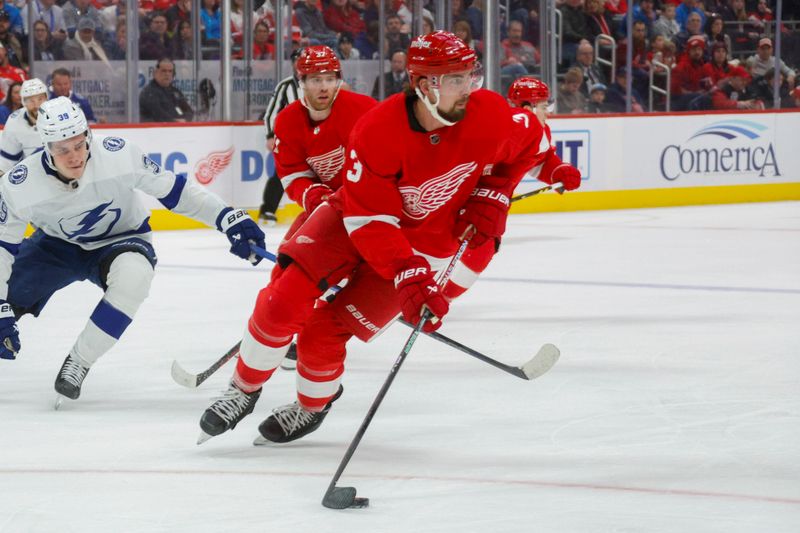 Jan 21, 2024; Detroit, Michigan, USA; Detroit Red Wings defenseman Justin Holl (3) handles the puck during the first period at Little Caesars Arena. Mandatory Credit: Brian Bradshaw Sevald-USA TODAY Sports