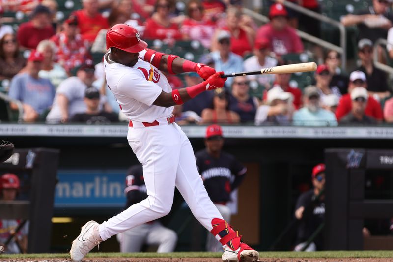 Mar 5, 2024; Jupiter, Florida, USA; St. Louis Cardinals right fielder Jordan Walker (18) hits an rbi single against the Minnesota Twins during the third inning at Roger Dean Chevrolet Stadium. Mandatory Credit: Sam Navarro-USA TODAY Sports