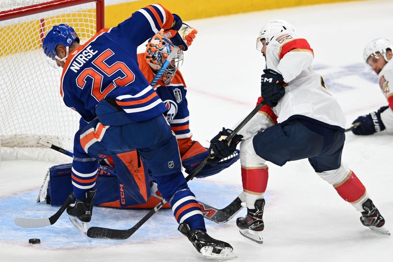 Jun 4, 2025; Edmonton, Alberta, CAN; Edmonton Oilers defenseman Darnell Nurse (25) deflects a shot against the Florida Panthers during the second period in game one of the 2025 Stanley Cup Final at Rogers Place. Mandatory Credit: Walter Tychnowicz-Imagn Images