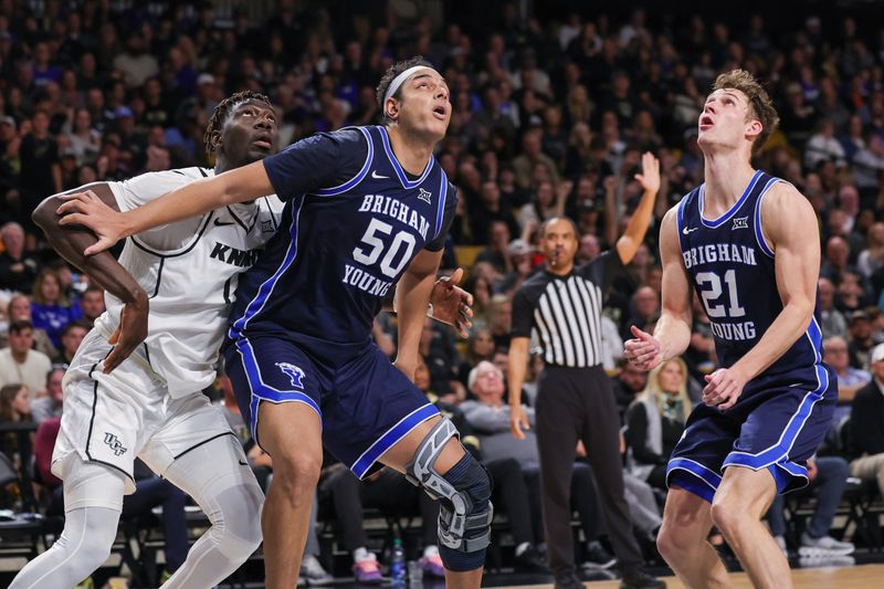 Jan 13, 2024; Orlando, Florida, USA; Brigham Young Cougars center Aly Khalifa (50) guard Trevin Knell (21) and UCF Knights forward Ibrahima Diallo (11) look for the rebound during the second half at Addition Financial Arena. Mandatory Credit: Mike Watters-USA TODAY Sports