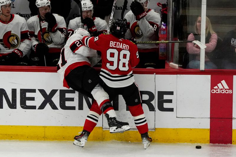Feb 17, 2024; Chicago, Illinois, USA; Chicago Blackhawks center Connor Bedard (98) checks Ottawa Senators right wing Mathieu Joseph (21) during the third period at United Center. Mandatory Credit: David Banks-USA TODAY Sports