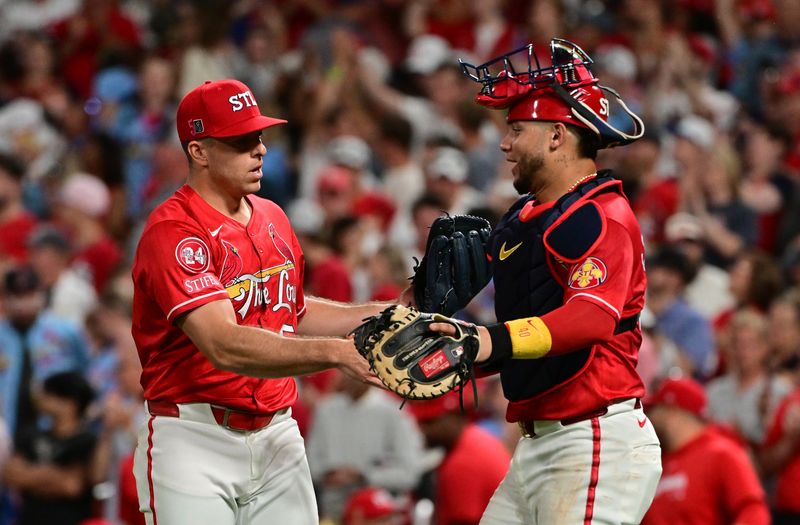 Aug 17, 2024; St. Louis, Missouri, USA;  St. Louis Cardinals relief pitcher Ryan Helsley (56) is congratulated by St. Louis Cardinals catcher Willson Contreras (40) in the ninth inning after the St. Louis Cardinals defeated the Los Angeles Dodgers at Busch Stadium. Mandatory Credit: Tim Vizer-USA TODAY Sports