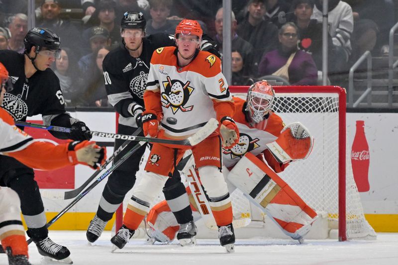 Dec 27, 2025; Los Angeles, California, USA; Anaheim Ducks defenseman Jackson Lacombe (2) gets in front of Los Angeles Kings right wing Corey Perry (10) and goaltender Lukas Dostal (1) as he blocks a shot by Los Angeles Kings right wing Quinton Byfield (55) in the first period at Crypto.com Arena. Mandatory Credit: Jayne Kamin-Oncea-Imagn Images