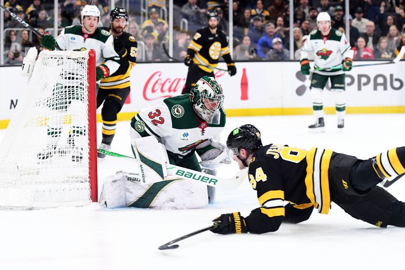 Mar 28, 2026; Boston, Massachusetts, USA; Minnesota Wild goaltender Filip Gustavsson (32) makes a save on Boston Bruins left wing Tanner Jeannot (84) during the first period at TD Garden. Mandatory Credit: Bob DeChiara-Imagn Images