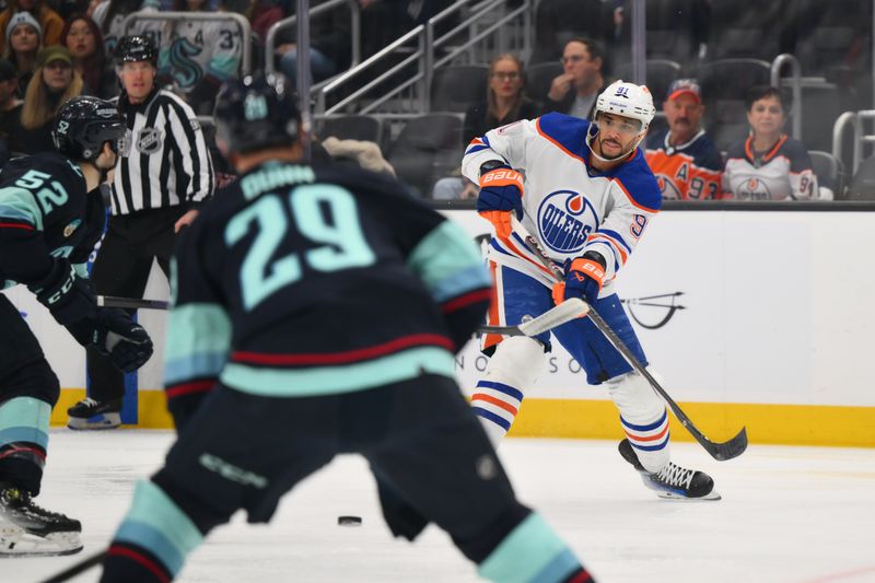 Mar 2, 2024; Seattle, Washington, USA; Edmonton Oilers left wing Evander Kane (91) passes the puck against the Seattle Kraken during the first period at Climate Pledge Arena. Mandatory Credit: Steven Bisig-USA TODAY Sports