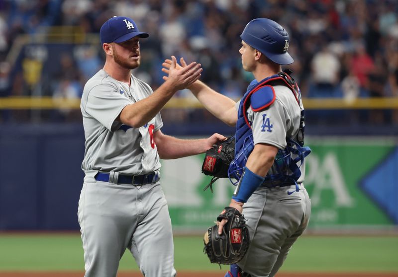 May 27, 2023; St. Petersburg, Florida, USA; Los Angeles Dodgers relief pitcher Caleb Ferguson (64) celebrates with catcher Will Smith (16) after defeating the Tampa Bay Rays  at Tropicana Field. Mandatory Credit: Kim Klement-USA TODAY Sports