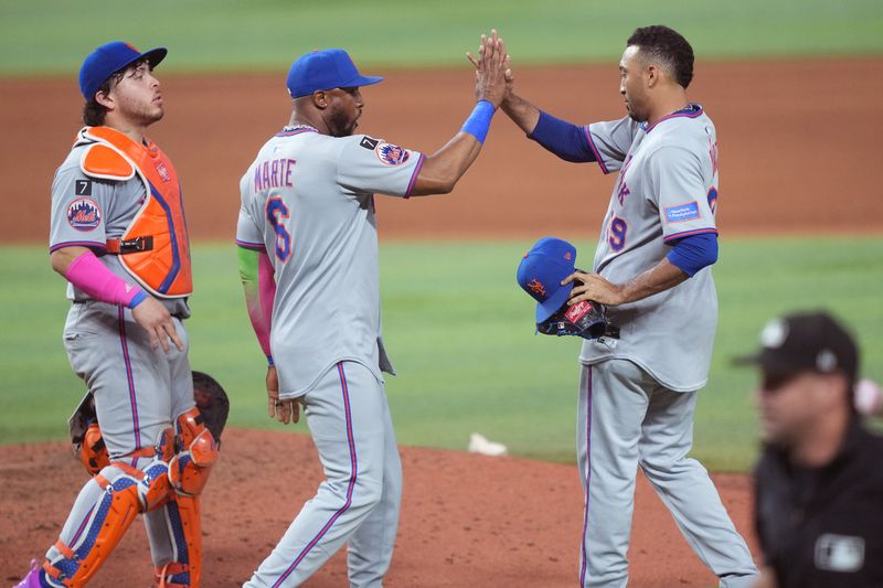 Sep 27, 2025; Miami, Florida, USA;  New York Mets pitcher Edwin Díaz (39) is congratulated by New York Mets designated hitter Starling Marte (6) following a victory over the Miami Marlins at loanDepot Park. Mandatory Credit: Jim Rassol-Imagn Images