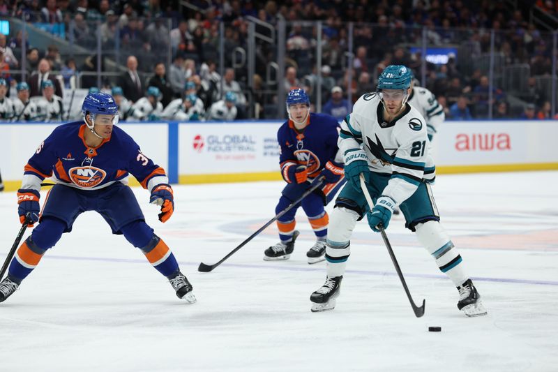 Jan 18, 2025; Elmont, New York, USA;  San Jose Sharks center Alexander Wennberg (21) skates up ice against the New York Islanders during the first period at UBS Arena. Mandatory Credit: Thomas Salus-Imagn Images