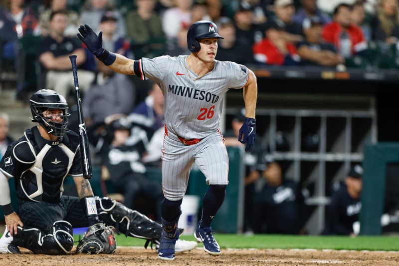 Apr 29, 2024; Chicago, Illinois, USA; Minnesota Twins outfielder Max Kepler (26) hits an RBI-single against the Chicago White Sox during the ninth inning at Guaranteed Rate Field. Mandatory Credit: Kamil Krzaczynski-USA TODAY Sports