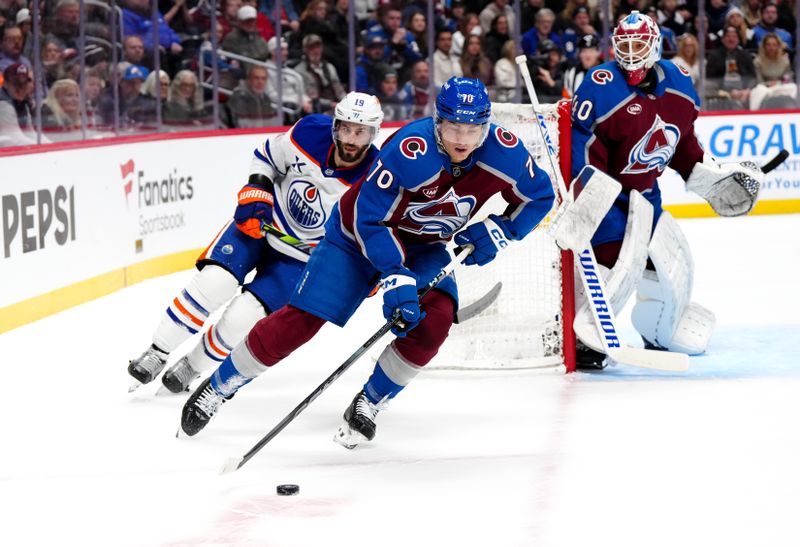 Nov 30, 2024; Denver, Colorado, USA; Edmonton Oilers center Adam Henrique (19) chases down Colorado Avalanche defenseman Sam Malinski (70) in the first period at Ball Arena. Mandatory Credit: Ron Chenoy-Imagn Images