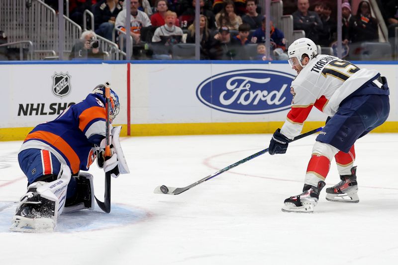 Mar 28, 2026; Elmont, New York, USA; Florida Panthers left wing Matthew Tkachuk (19) shoots and scores against New York Islanders goaltender Ilya Sorokin (30) during the first period at UBS Arena. Mandatory Credit: Brad Penner-Imagn Images