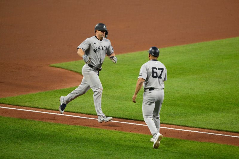 Apr 30, 2025; Baltimore, Maryland, USA; New York Yankees first baseman Paul Goldschmidt (48) celebrates with third base/outfield coach Luis Rojas (67) after hitting a home run during the fifth inning against the Baltimore Orioles at Oriole Park at Camden Yards. Mandatory Credit: Reggie Hildred-Imagn Images