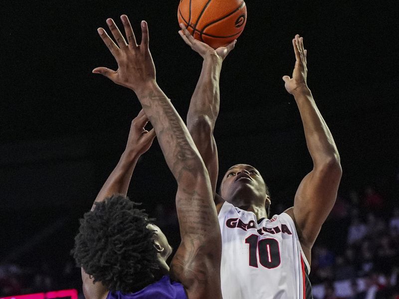 Nov 4, 2024; Athens, Georgia, USA; Georgia Bulldogs forward RJ Godfrey (10) shoots over Tennessee Tech Golden Eagles forward Rodney Johnson Jr. (5) at Stegeman Coliseum. Mandatory Credit: Dale Zanine-Imagn Images
