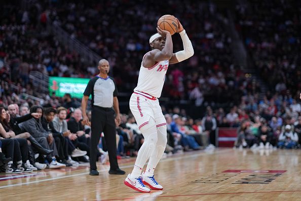 HOUSTON, TEXAS - DECEMBER 27: Aaron Holiday #0 of the Houston Rockets shoots a three point shot during the forth quarter of the game against the Phoenix Suns at Toyota Center on December 27, 2023 in Houston, Texas. User expressly acknowledges and agrees that, by downloading and or using this photograph, User is consenting to the terms and conditions of the Getty Images License Agreement. (Photo by Alex Bierens de Haan/Getty Images)