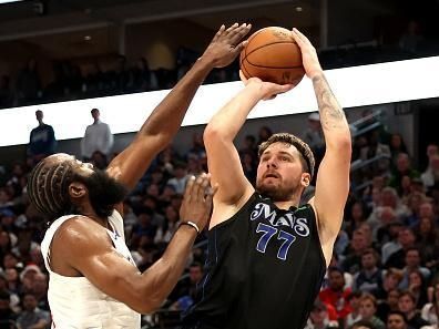 DALLAS, TEXAS - DECEMBER 20: Luka Doncic #77 of the Dallas Mavericks shoots the ball while defended by James Harden #1 of the LA Clippers in the first half at American Airlines Center on December 20, 2023 in Dallas, Texas. NOTE TO USER: User expressly acknowledges and agrees that, by downloading and or using this photograph, User is consenting to the terms and conditions of the Getty Images License Agreement. (Photo by Tim Heitman/Getty Images)