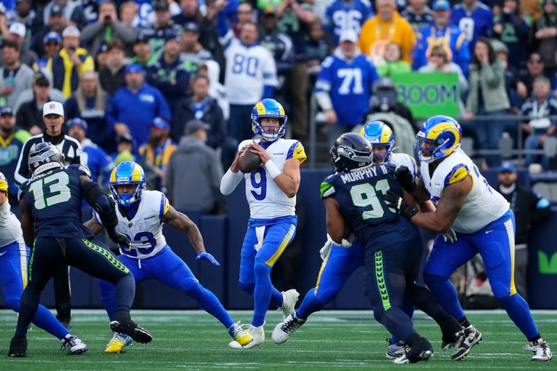 Los Angeles Rams quarterback Matthew Stafford (9) drops back to pass against the Seattle Seahawks during the first half of an NFL football game in Seattle, Sunday, Nov. 3, 2024. (AP Photo/Lindsey Wasson)