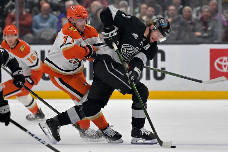 Dec 27, 2025; Los Angeles, California, USA;Los Angeles Kings right wing Adrian Kempe (9) is defended by Anaheim Ducks right wing Frank Vatrano (77) as he handles the puck in the first period at Crypto.com Arena. Mandatory Credit: Jayne Kamin-Oncea-Imagn Images