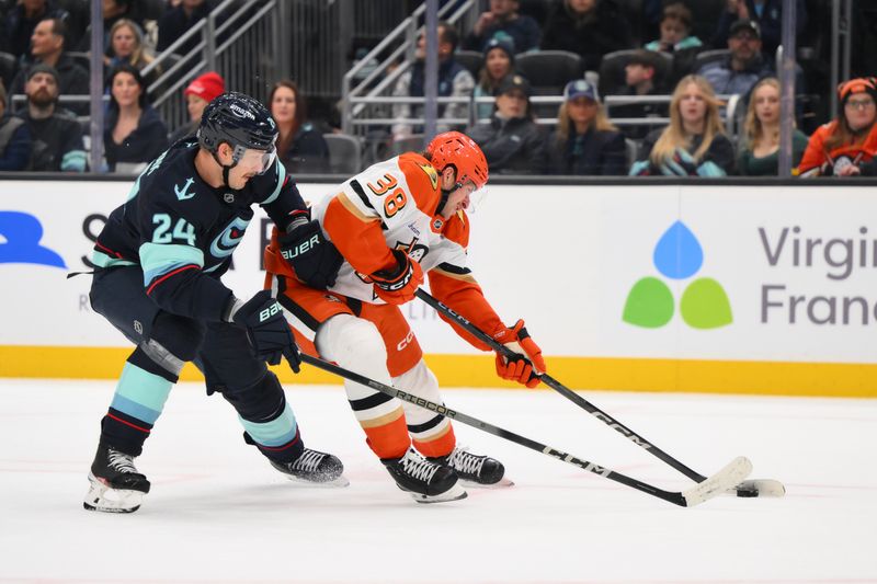 Nov 27, 2024; Seattle, Washington, USA; Anaheim Ducks center Jansen Harkins (38) plays the puck while defended by Seattle Kraken defenseman Jamie Oleksiak (24) during the second period at Climate Pledge Arena. Mandatory Credit: Steven Bisig-Imagn Images