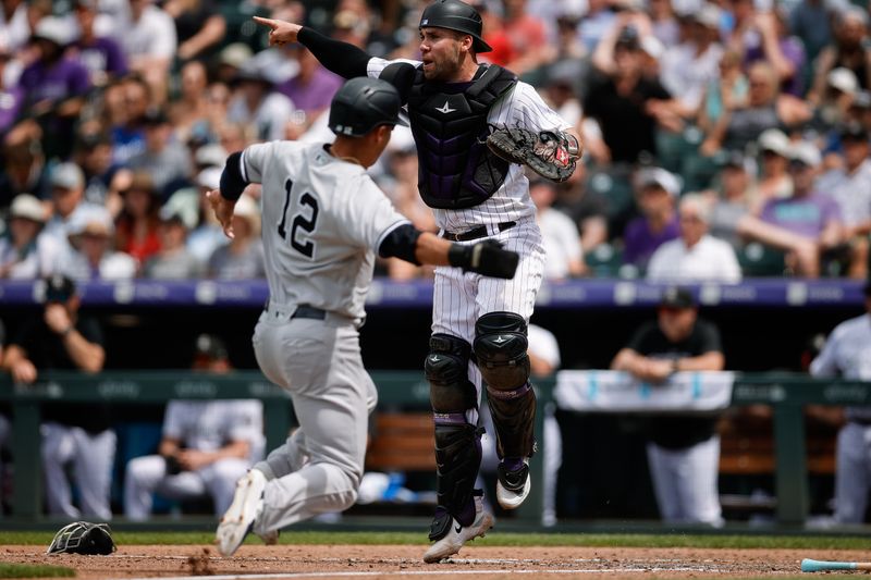 Jul 16, 2023; Denver, Colorado, USA; Colorado Rockies catcher Austin Wynns (16) gestures to first base as New York Yankees left fielder Isiah Kiner-Falefa (12) slides in to score in the sixth inning at Coors Field. Mandatory Credit: Isaiah J. Downing-USA TODAY Sports