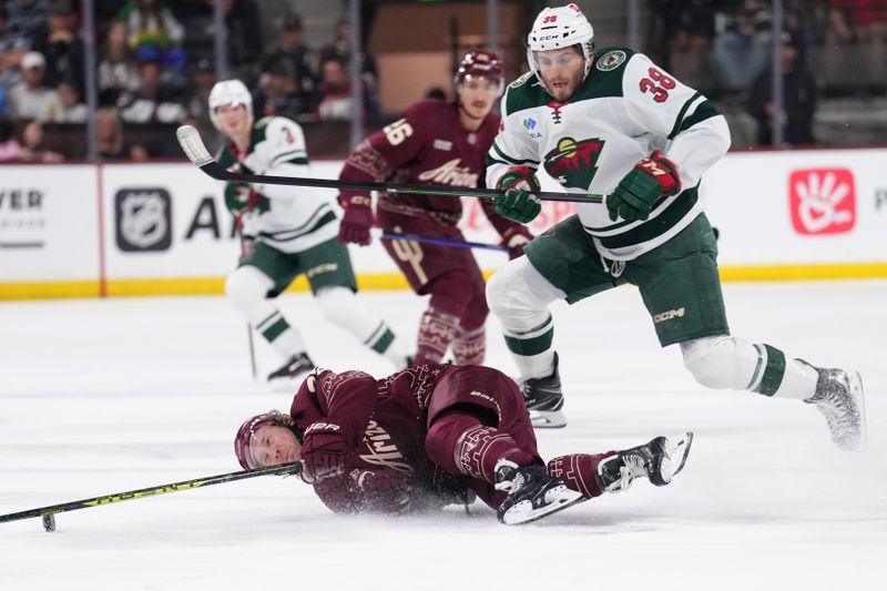 Mar 12, 2023; Tempe, Arizona, USA; Minnesota Wild right wing Ryan Hartman (38) trips Arizona Coyotes center Travis Boyd (72) during the first period at Mullett Arena. Mandatory Credit: Joe Camporeale-USA TODAY Sports