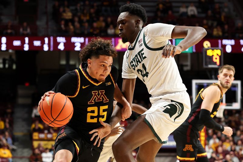 Dec 4, 2024; Minneapolis, Minnesota, USA; Minnesota Golden Gophers guard Lu'Cye Patterson (25) works around Michigan State Spartans forward Xavier Booker (34) during the first half at Williams Arena. Mandatory Credit: Matt Krohn-Imagn Images